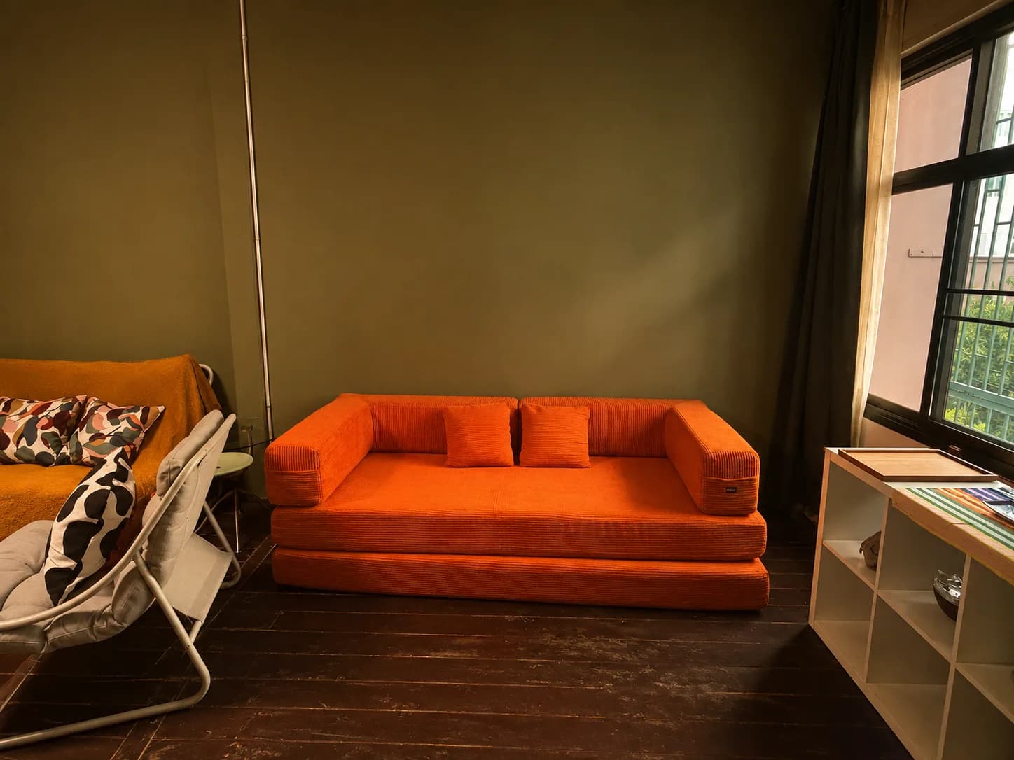 Orange sofa in the Creative Loft living room